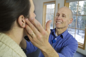 Michael Cheslak, PT, DPT, OCS, examines a patient's jaw for TMD.